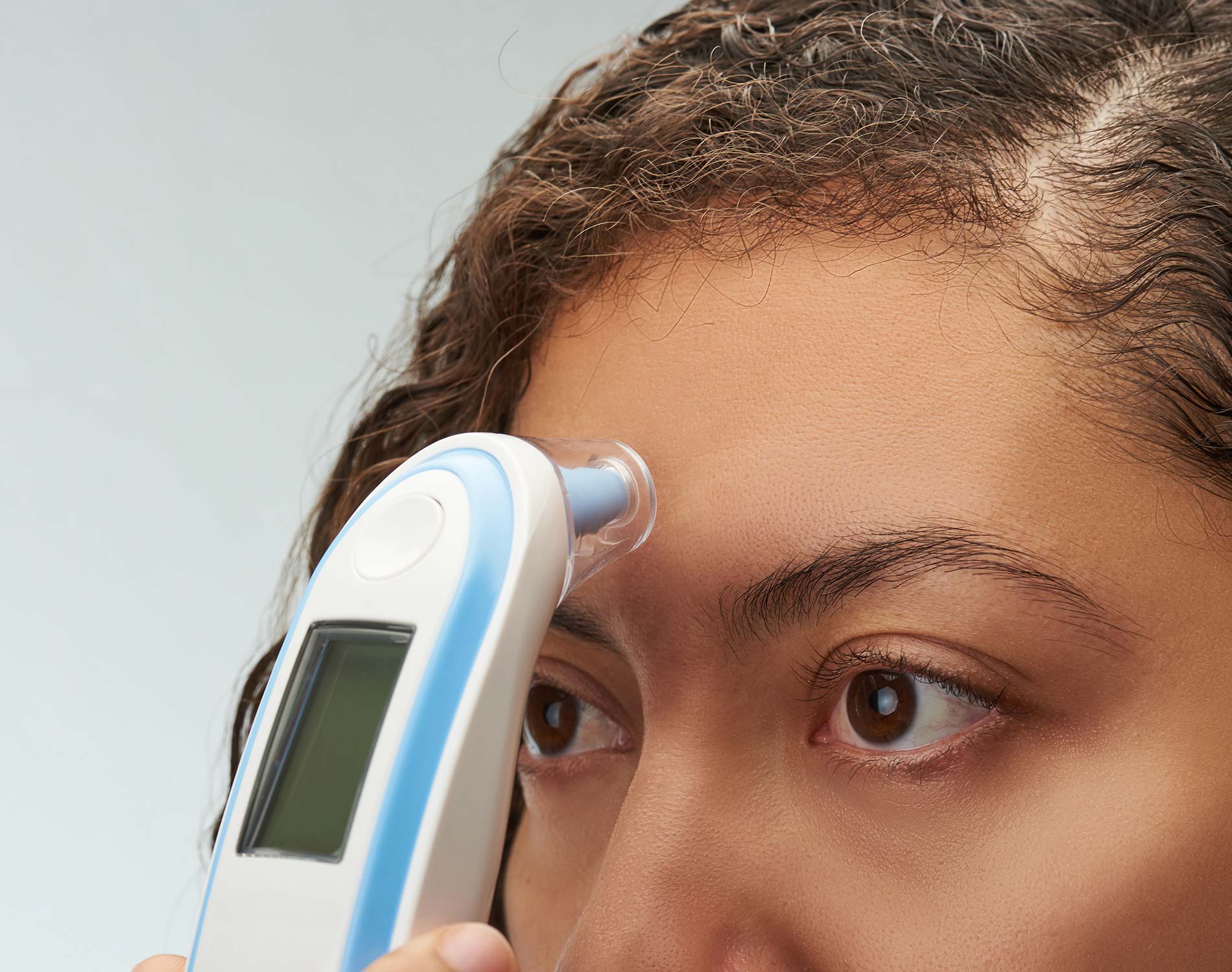 Woman using digital thermometer