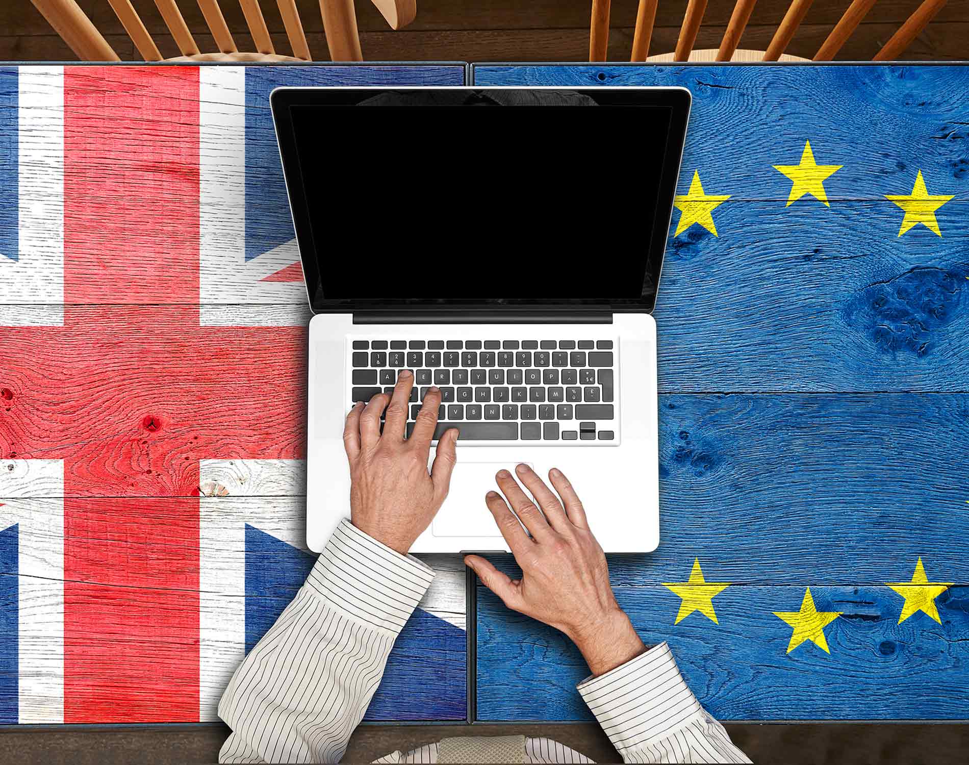 European and UK flagged wooden Table with laptop