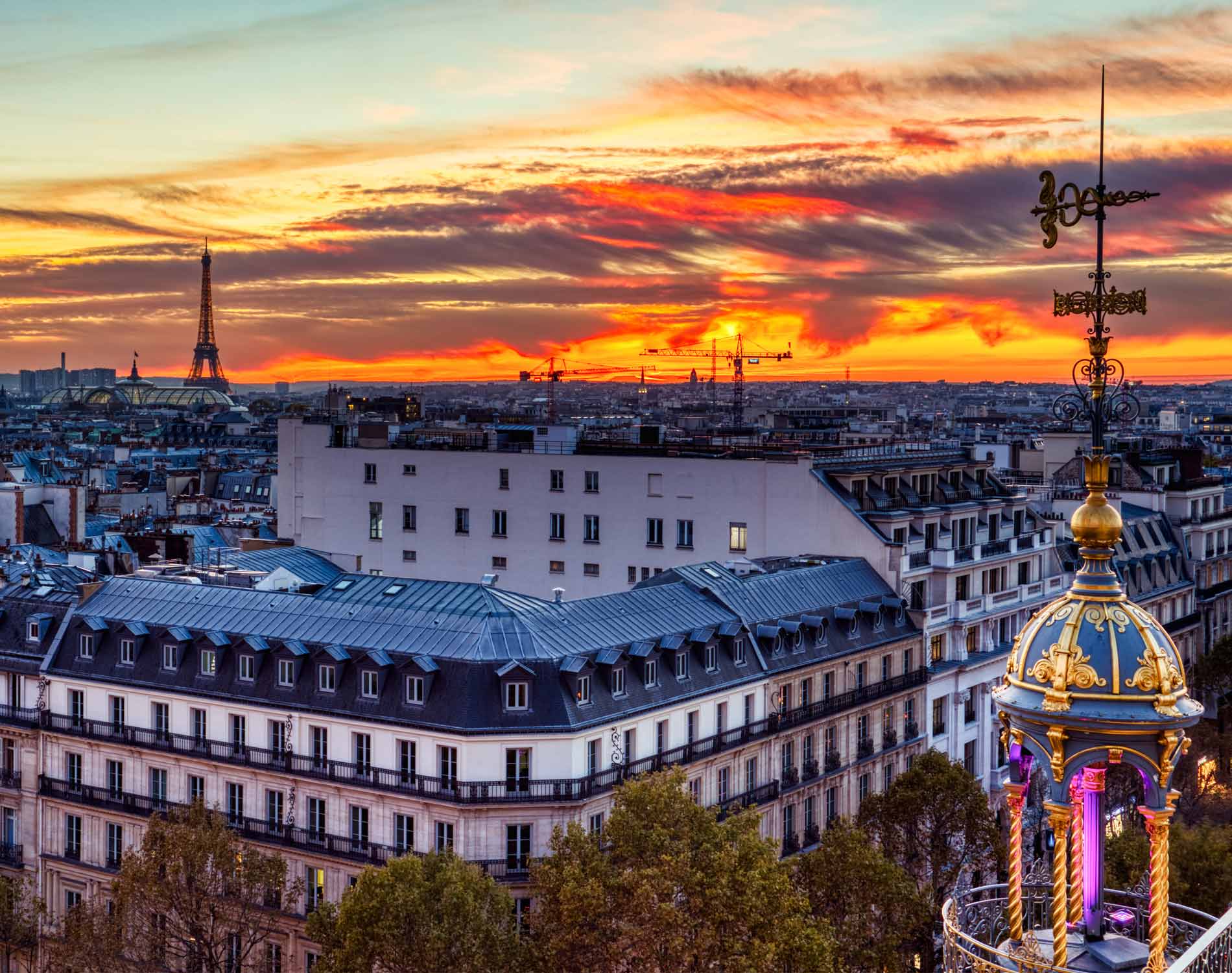 Aerial view of illuminated Paris at dusk with Eiffel Tower