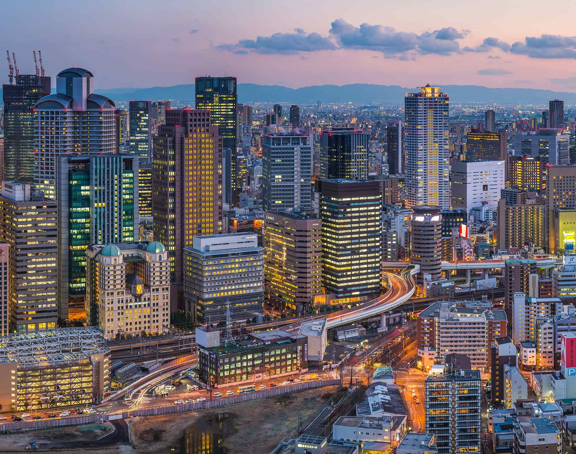 Neon night skyscraper cityscape futuristic city illuminated panorama Osaka Japan