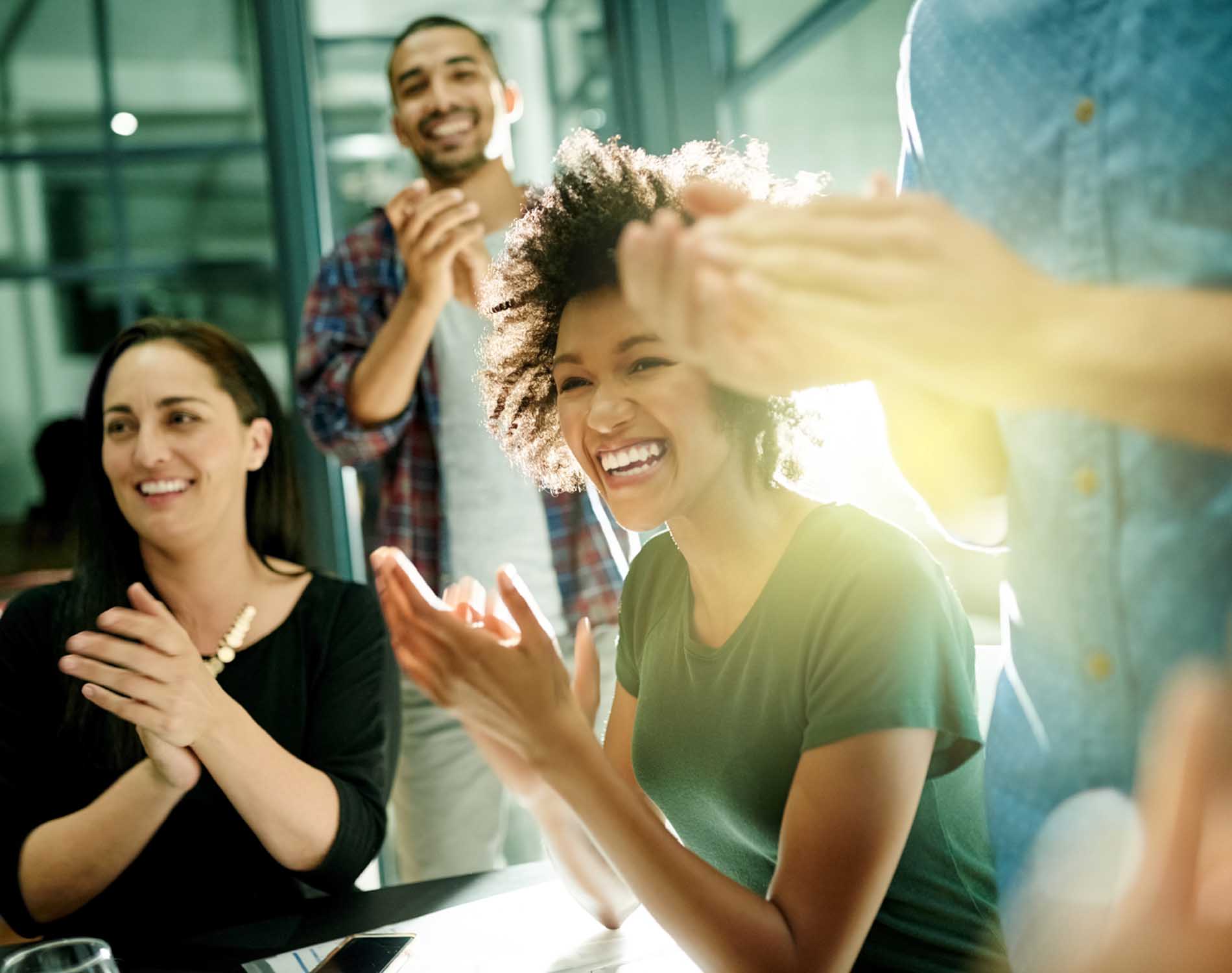 team of creative businesspeople applauding an achievement