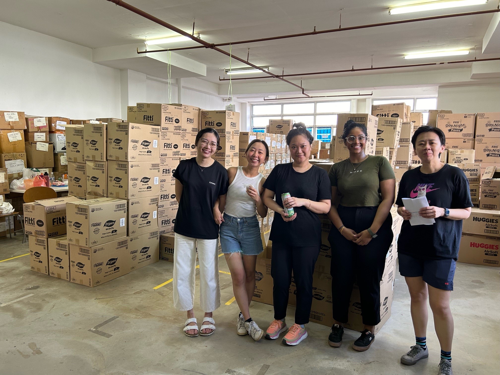 Volunteers from our Dentons Women Mentorship Group distributing milk and diapers for disadvantaged families with young children