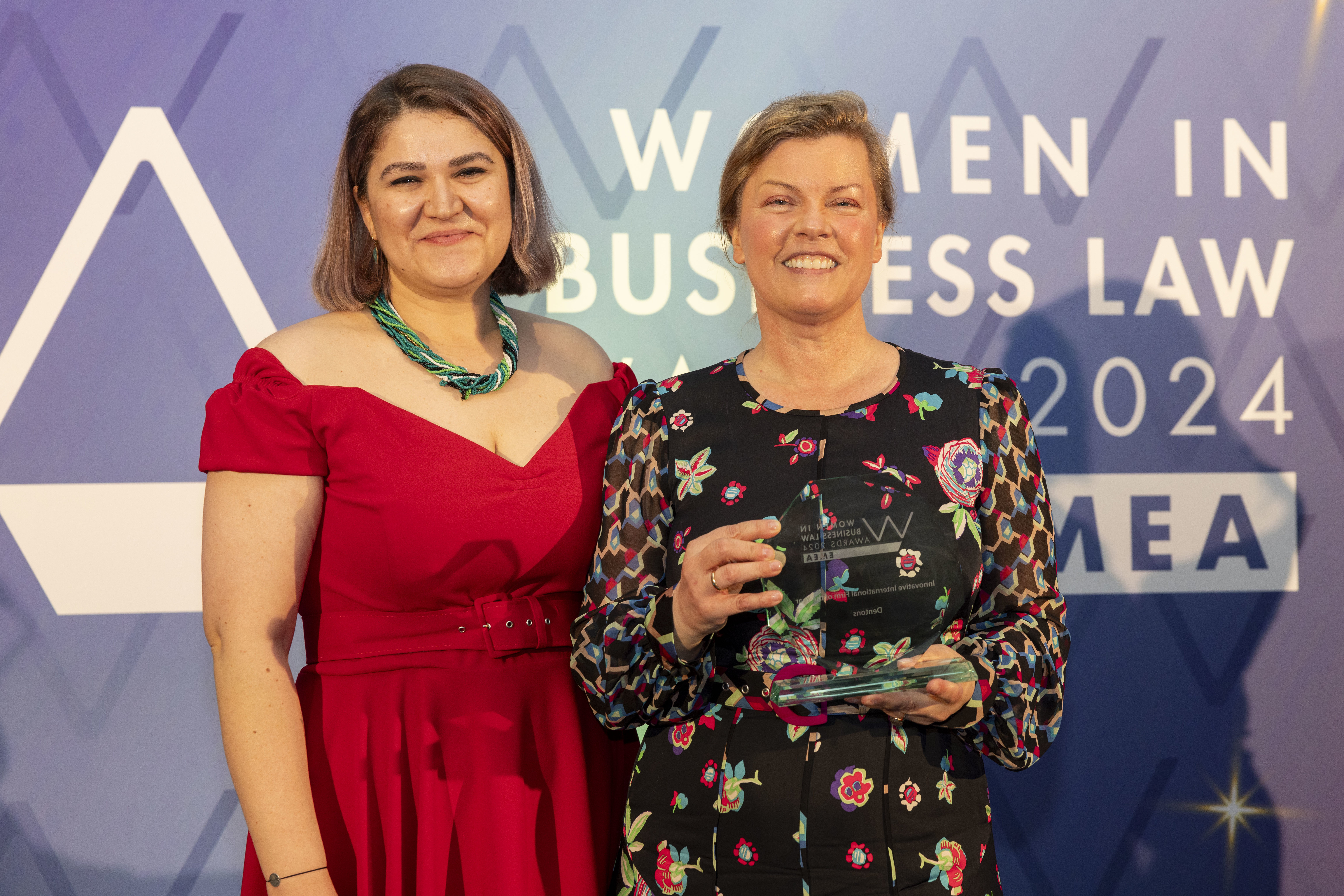 Two women holding award