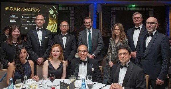 Photo showing group of legal professionals in a formal event beside the table