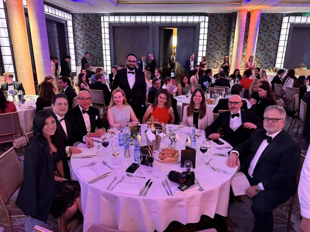 Photo showing group of legal professionals in a formal event beside the table