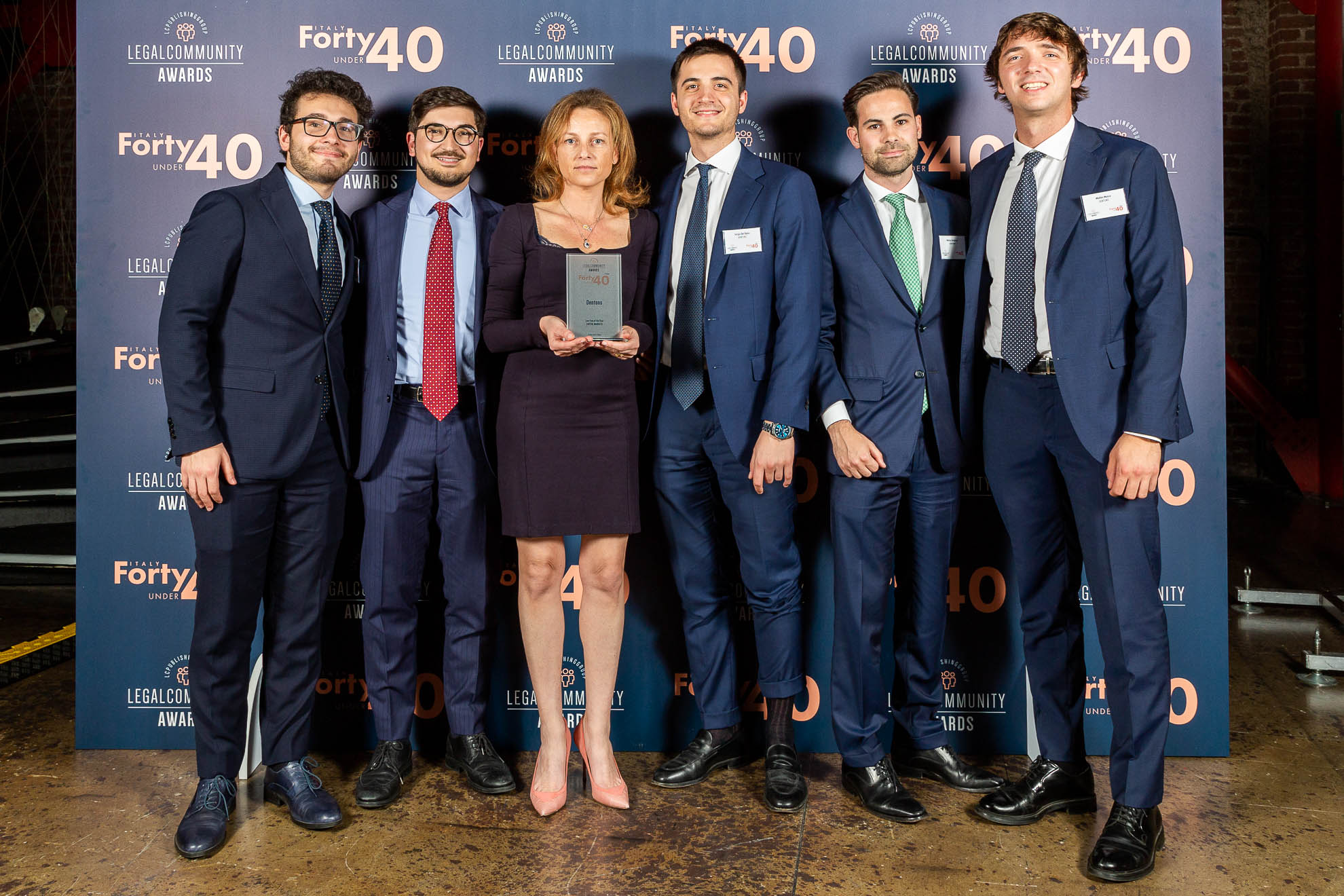 group of people holding the awards