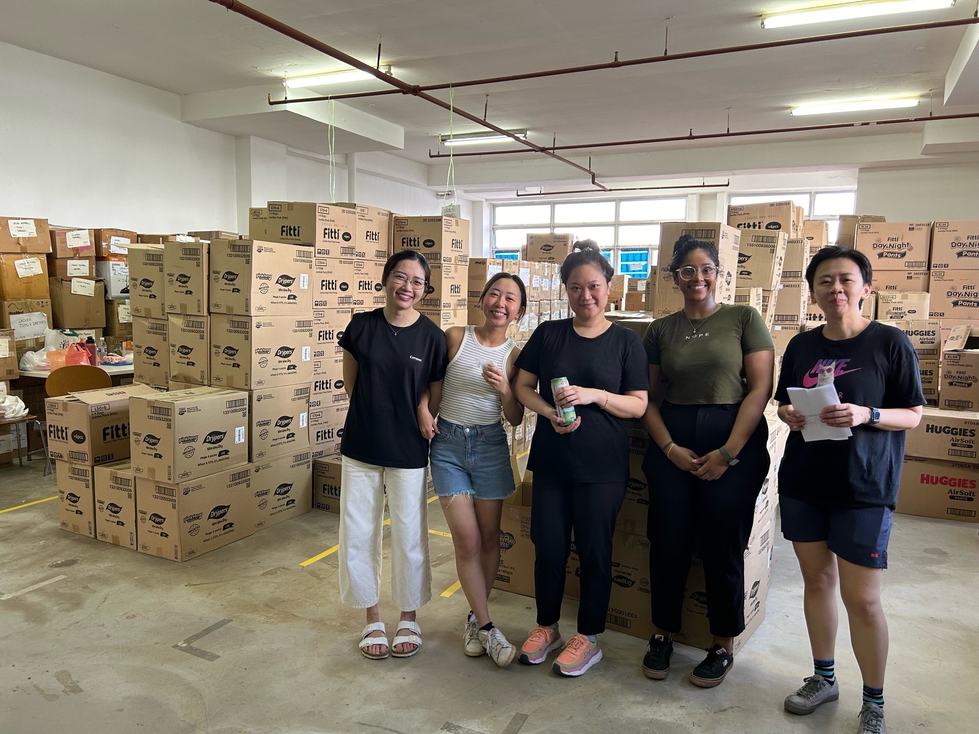 Volunteers from our Dentons Women Mentorship Group distributing milk and diapers for disadvantaged families with young children